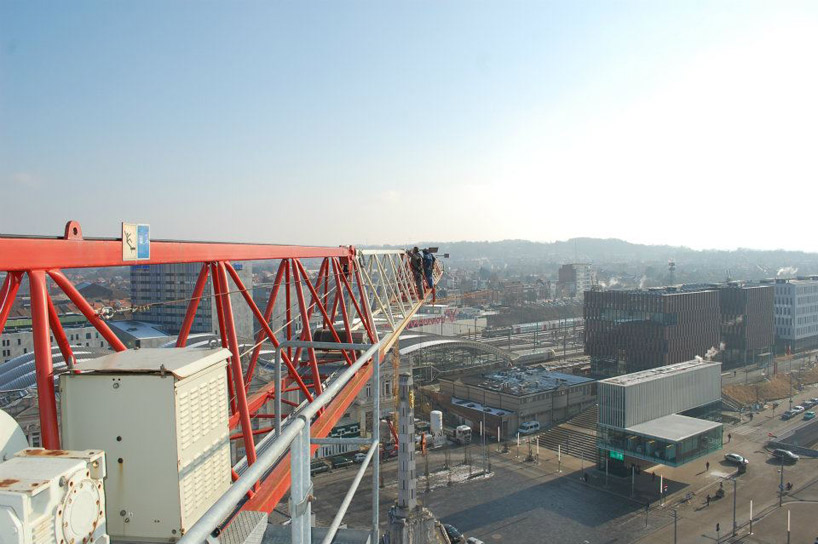 pivoting crane lamp by gijs van vaerenbergh creates 'skylight' in belgium