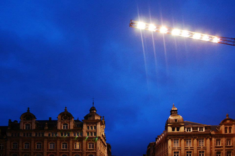 pivoting crane lamp by gijs van vaerenbergh creates 'skylight' in belgium