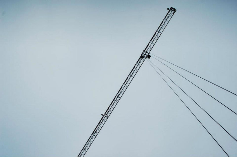 pivoting crane lamp by gijs van vaerenbergh creates 'skylight' in belgium