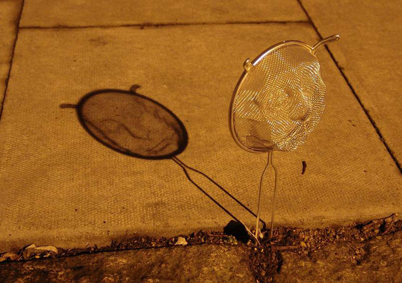 isaac cordal casts shadows with strainer faces - 1