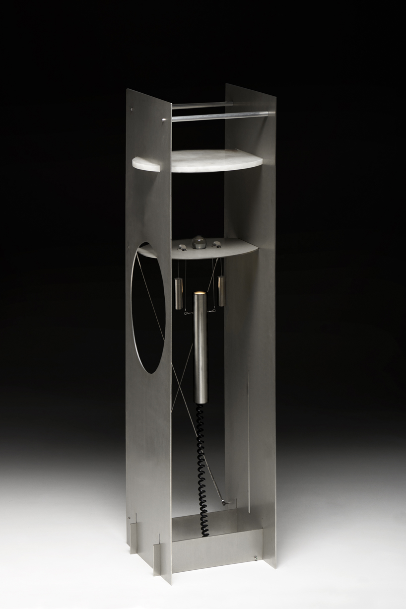 kinetic lighting activates mechanical movement in a sculpture of steel and glass