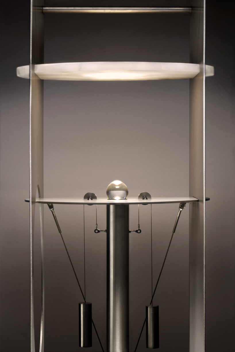 kinetic lighting activates mechanical movement in a sculpture of steel and glass