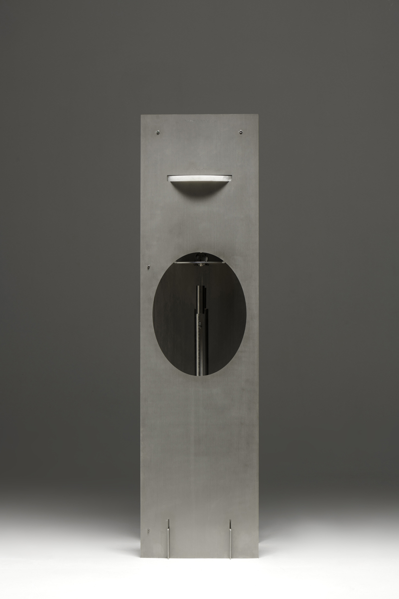 kinetic lighting activates mechanical movement in a sculpture of steel and glass