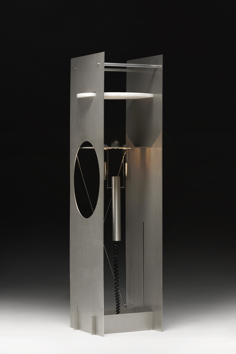 kinetic lighting activates mechanical movement in a sculpture of steel and glass