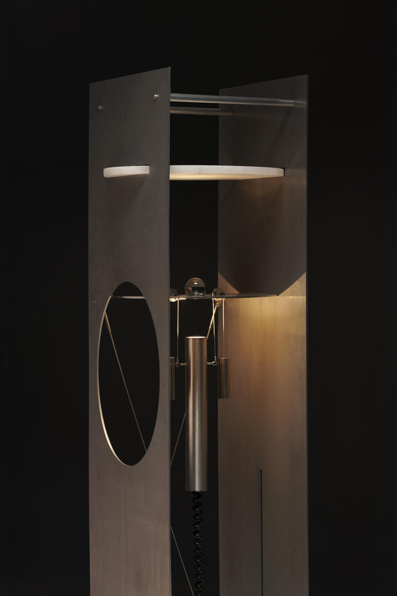 kinetic lighting activates mechanical movement in a sculpture of steel and glass