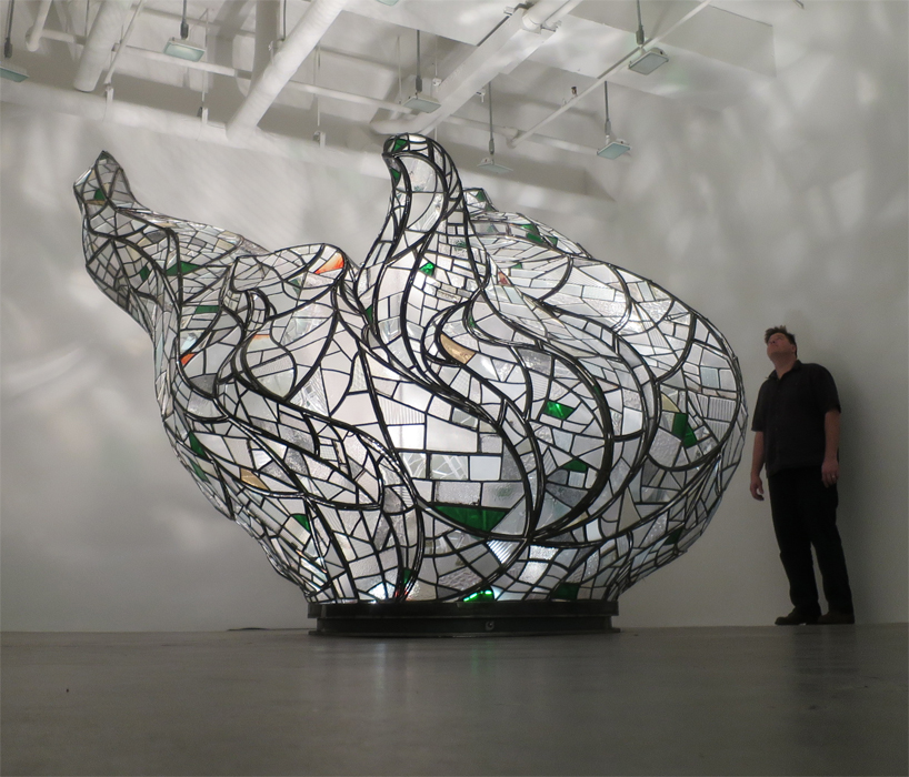 tom fruin sculpts statue of liberty flame from broken factory windows