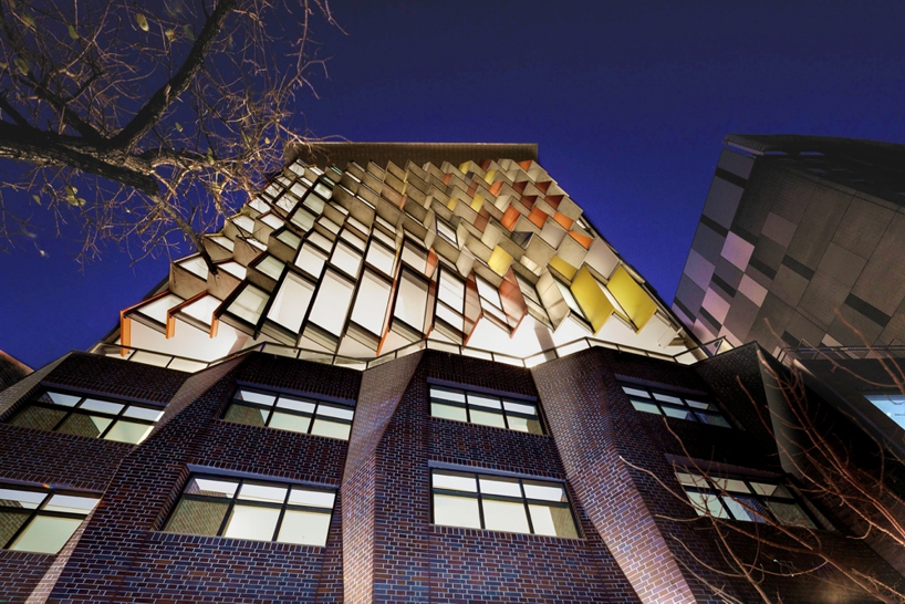 tony owen partners clads apartment building with colorful mosaic windows in australia