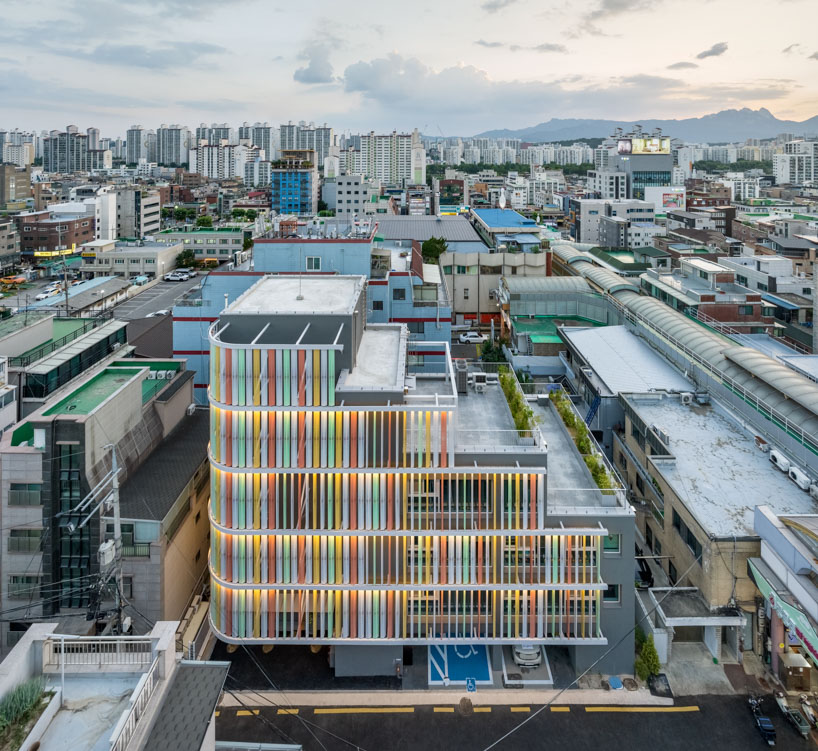 translucent facade of multicolored steel louvers unfolds along seoul’s dokkaebi market