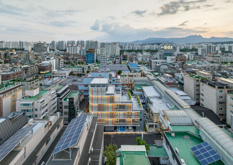 translucent facade of multicolored steel louvers unfolds along seoul’s dokkaebi market