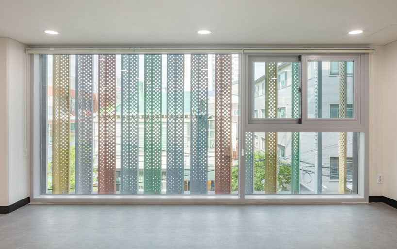 translucent facade of multicolored steel louvers unfolds along seoul’s dokkaebi market