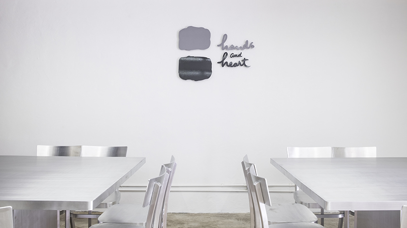 hand & heart café in bangkok by party / space / design uses a sleek aluminium interior