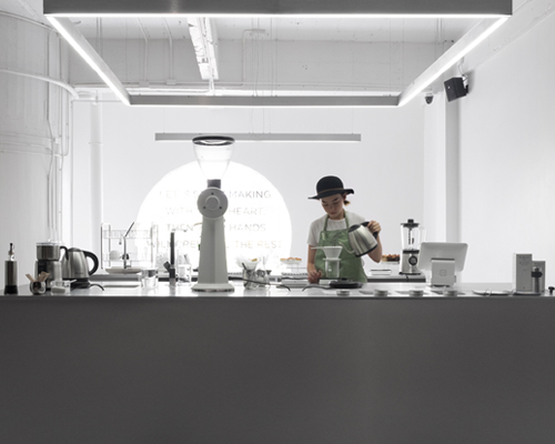 hand & heart café in bangkok by party / space / design uses a sleek aluminium interior