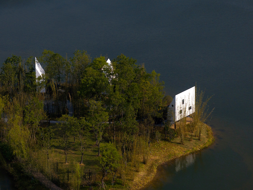 wood-clad cabins by wiki world stand on stilts like sailboats along wuhan's shoreline