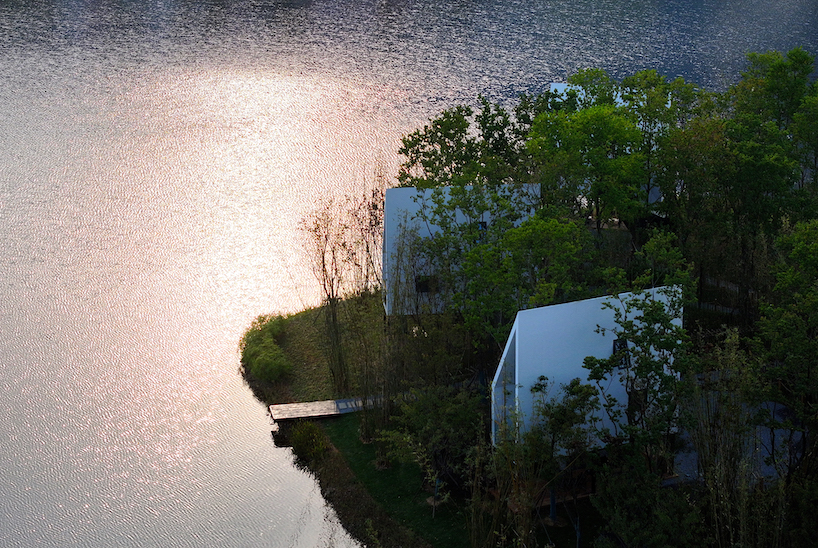 wood-clad cabins by wiki world stand on stilts like sailboats along wuhan's shoreline