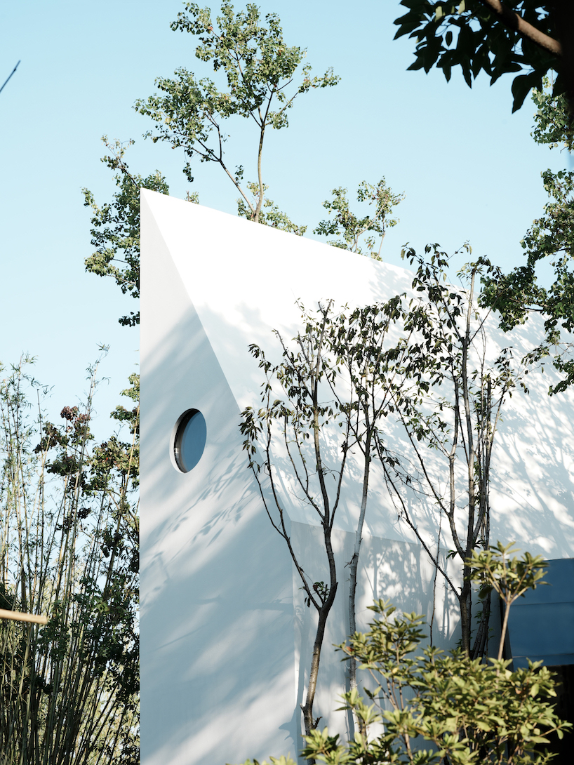 wood-clad cabins by wiki world stand on stilts like sailboats along wuhan's shoreline