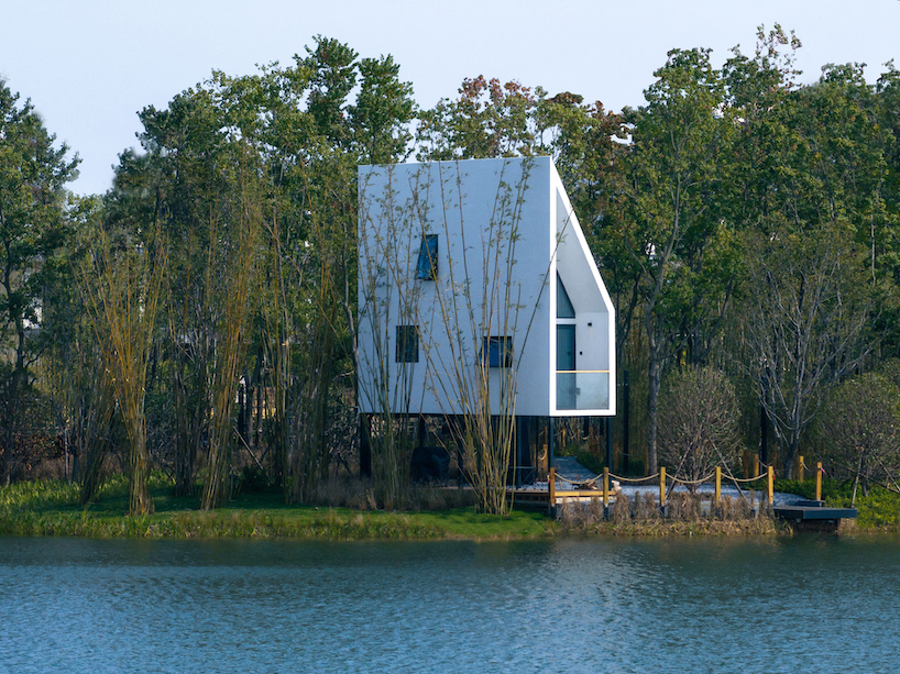 wood-clad cabins by wiki world stand on stilts like sailboats along wuhan's shoreline