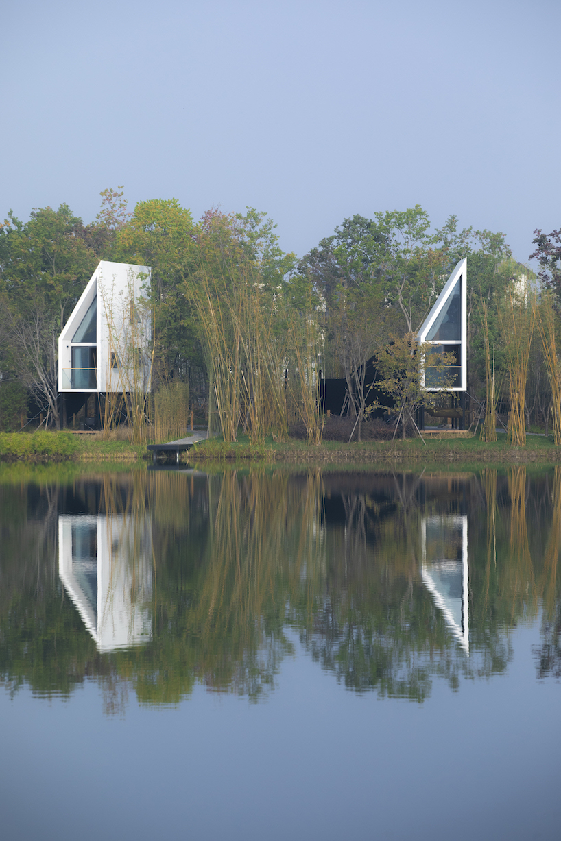 wood-clad cabins by wiki world stand on stilts like sailboats along wuhan's shoreline