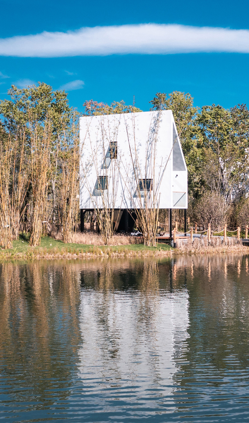 wood-clad cabins by wiki world stand on stilts like sailboats along wuhan's shoreline