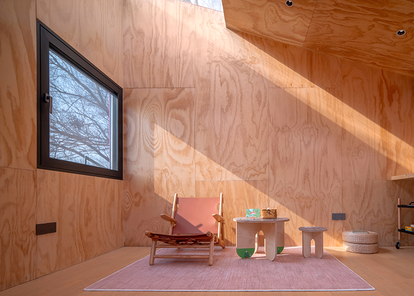 playful crimson timber cabin floats above a stream in chinese cultural park - 10