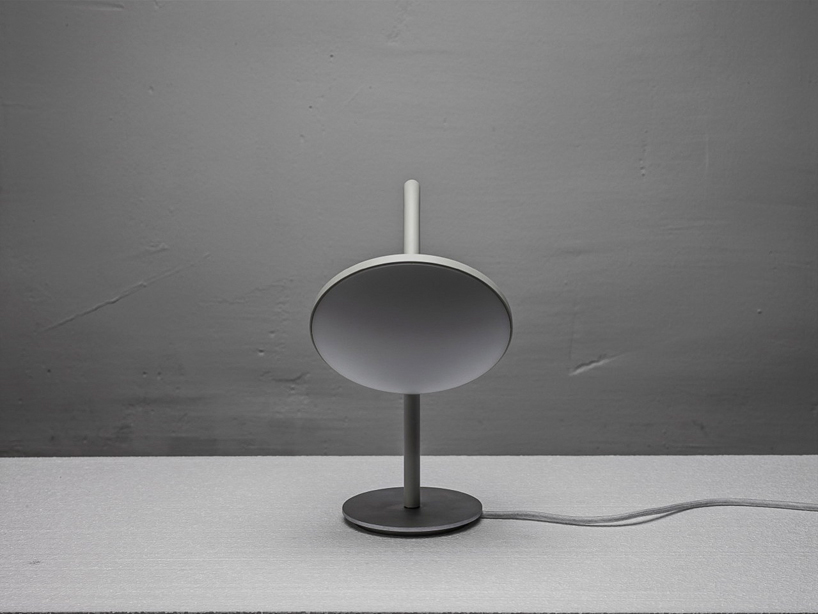 bao-nghi droste emits light from round table lamp's epicenter