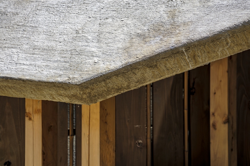 moss-covered earthen roof shields teahouse’s waiting area in japan