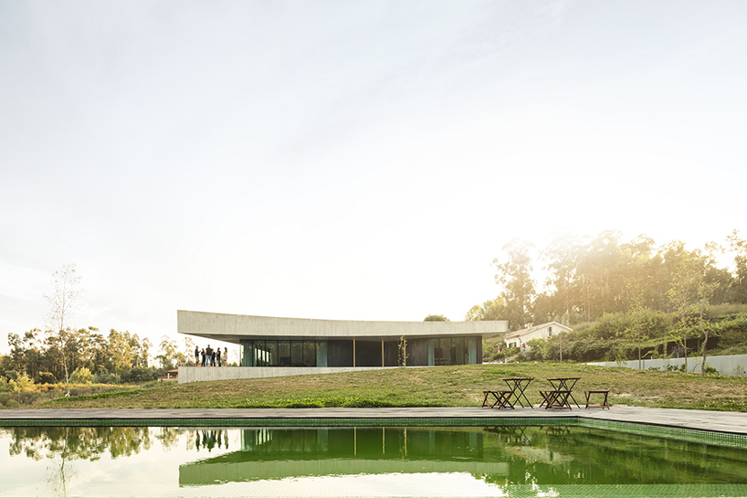 spaceworkers' cabo de vila house in portugal features mirrored concave sides - 1