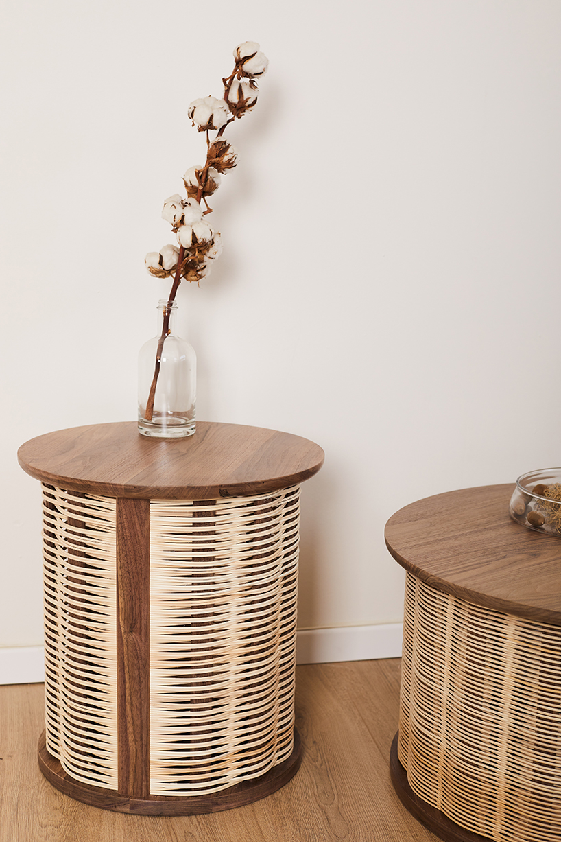 nadav caspi weaves natural wicker through walnut wood frames for table collection