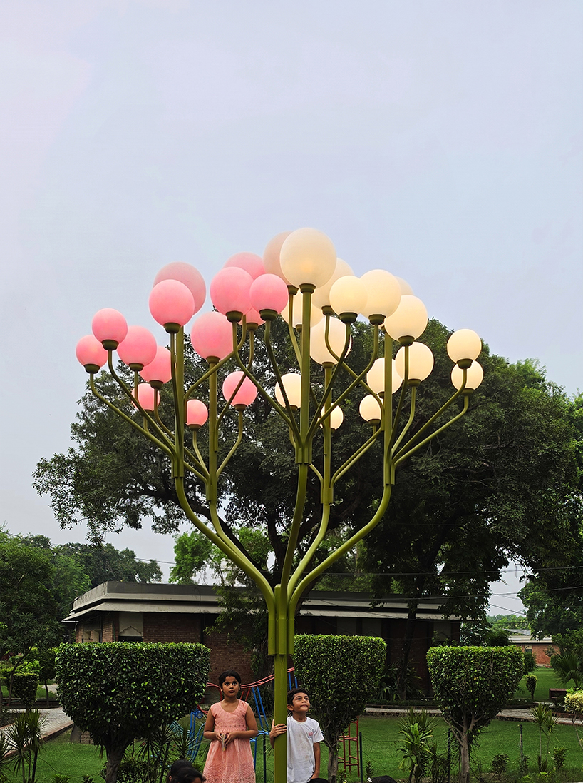 luminous globes extend from branched metal tree installation in pakistan - 5
