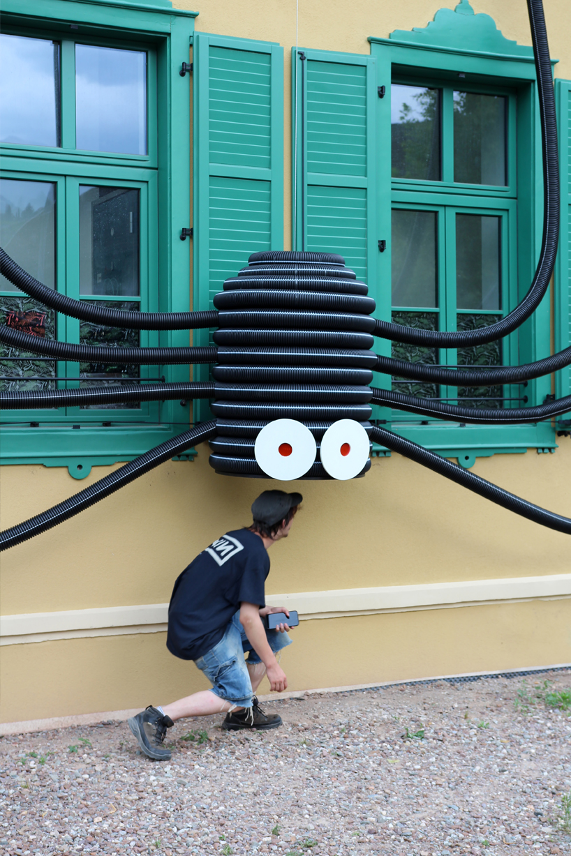 moradavaga's spider sprawls across facade in italy, reminiscent of an old-school string phone