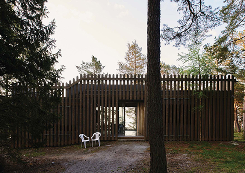 wooden hedge facade enfolds villa on the coastline of stockholm