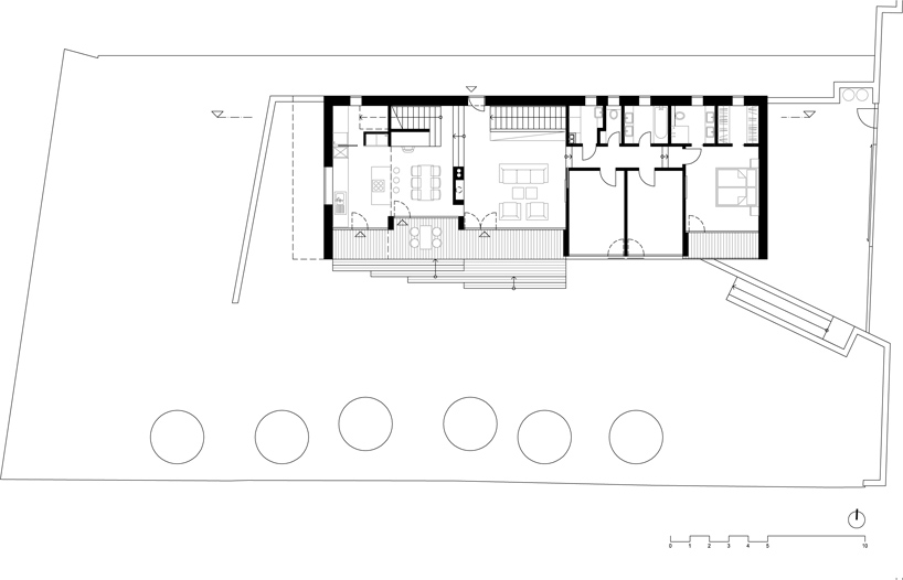 sloped semi cantilever house by grido architektura
