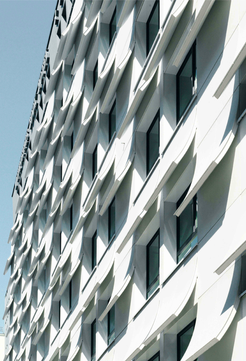 book pages transformed into a concrete hotel facade in munich