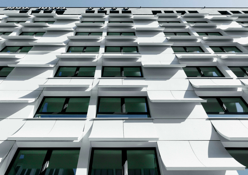 book pages transformed into a concrete hotel facade in munich