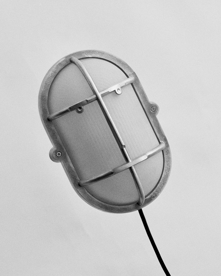 philippe tabet reimagines industrial bulkhead lamp as face-like lighting fixture