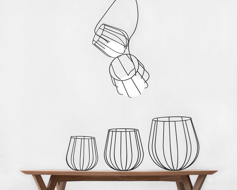 martín azúa suspends dipping metallic basket in light container