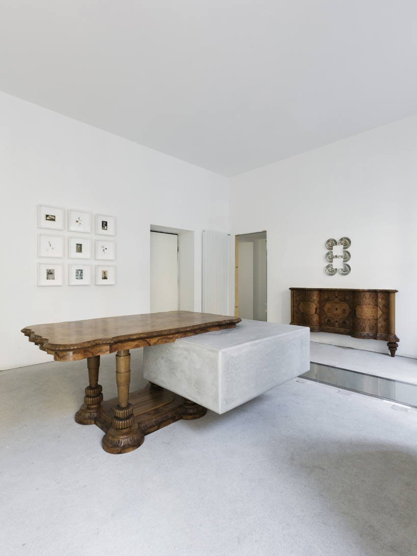 studio nucleo melds dramatic concrete blocks with antique furniture