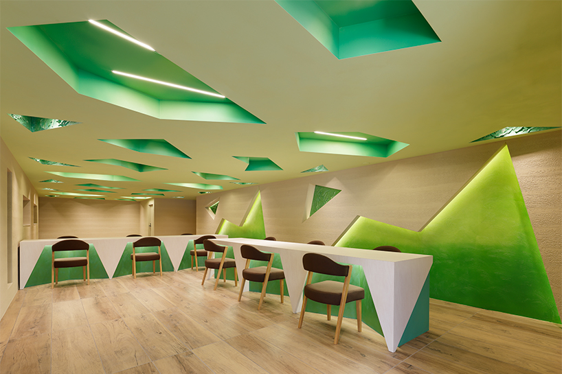 polygonal green cutouts animate kakushin tokyo office's interiors by moriyuki ochiai