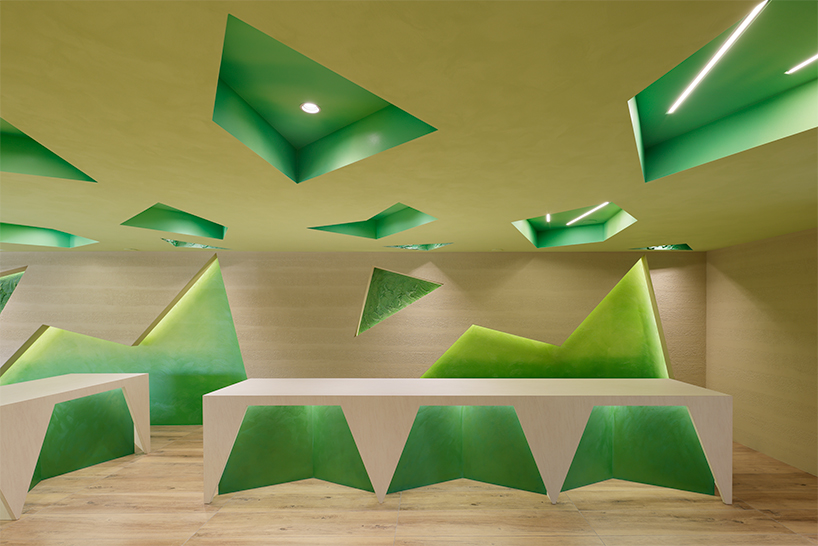 polygonal green cutouts animate kakushin tokyo office's interiors by moriyuki ochiai