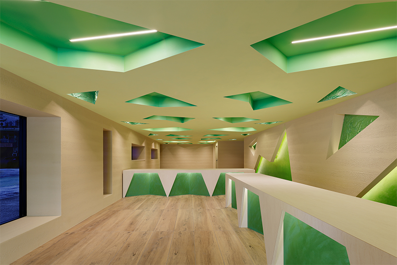 polygonal green cutouts animate kakushin tokyo office's interiors by moriyuki ochiai