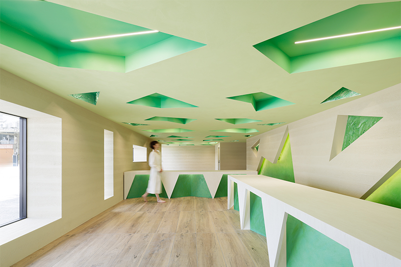 polygonal green cutouts animate kakushin tokyo office's interiors by moriyuki ochiai