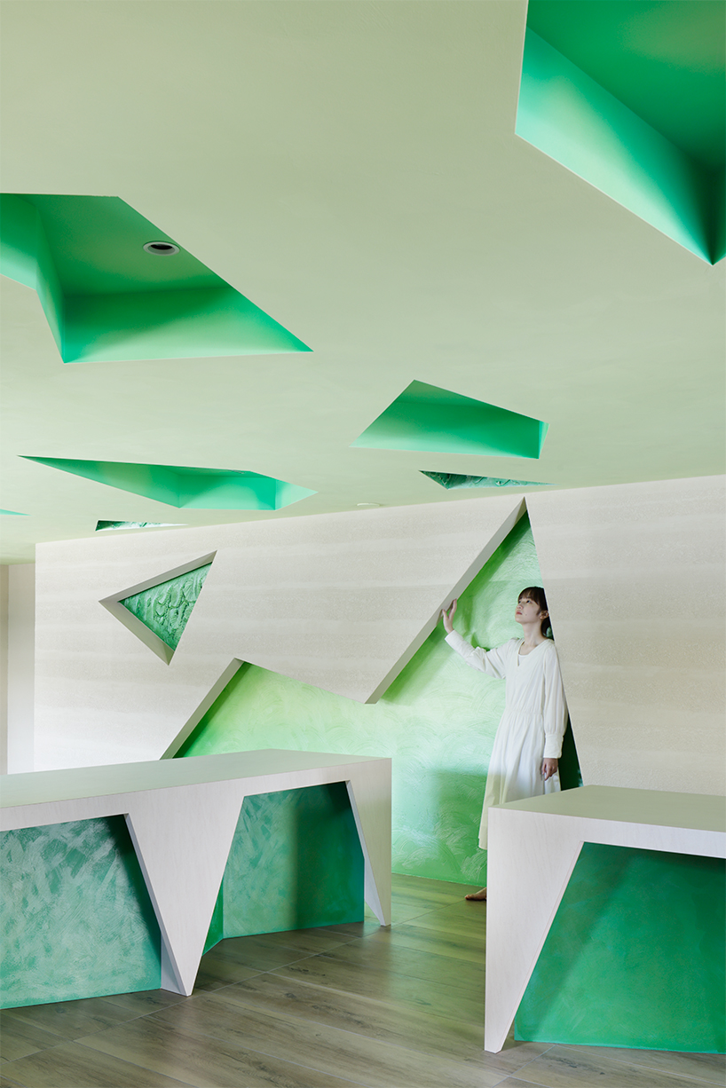 polygonal green cutouts animate kakushin tokyo office's interiors by moriyuki ochiai