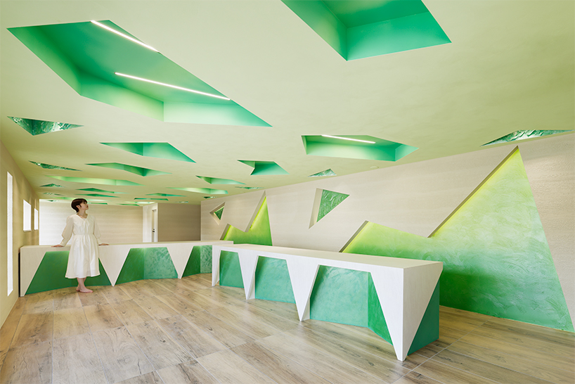 polygonal green cutouts animate kakushin tokyo office's interiors by moriyuki ochiai