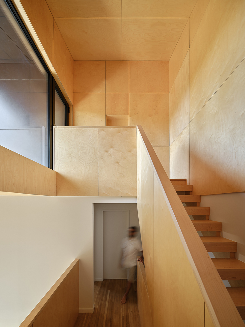 brick residence's sloping roof shields recessed outdoor balcony in toronto