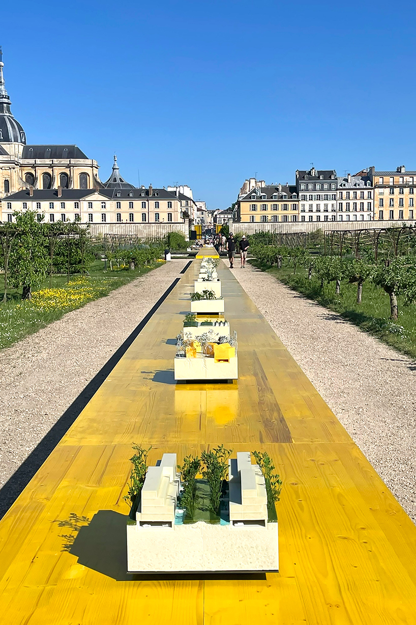 studio 5•5 stretches linear table through versailles' gardens as open dialogue on climate