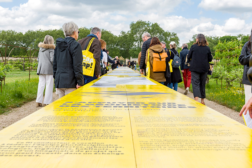 studio 5•5 stretches linear table through versailles' gardens as open dialogue on climate