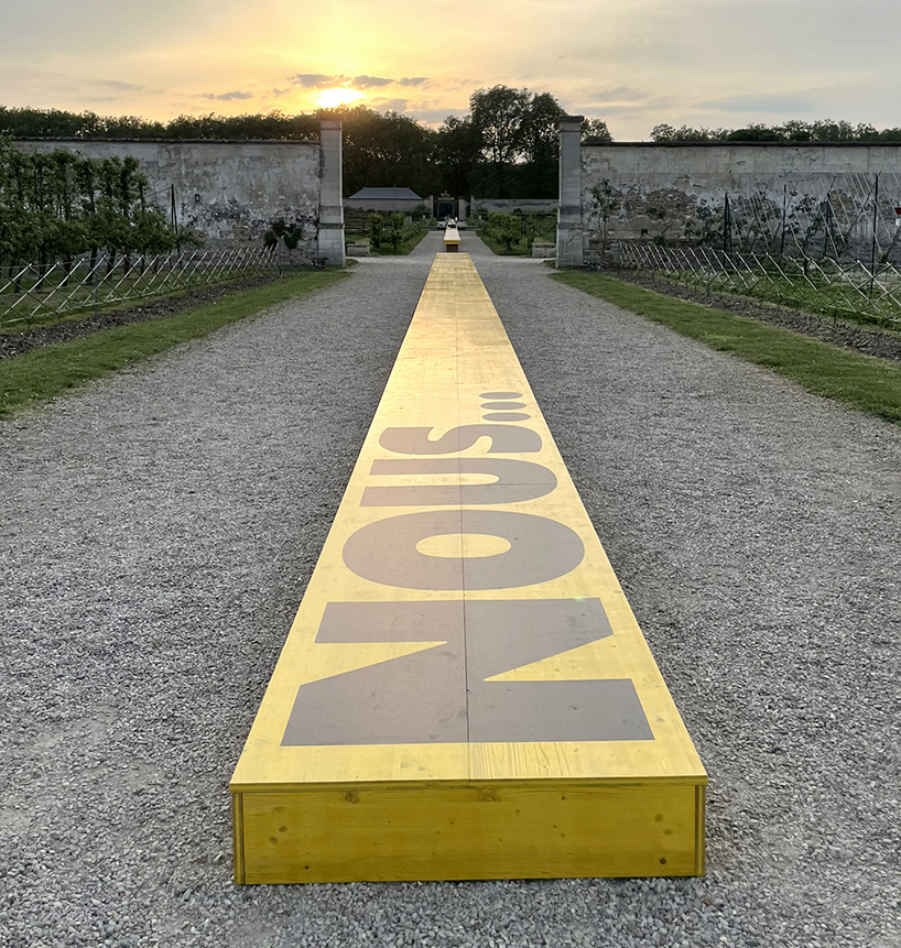 studio 5•5 stretches linear table through versailles' gardens as open dialogue on climate