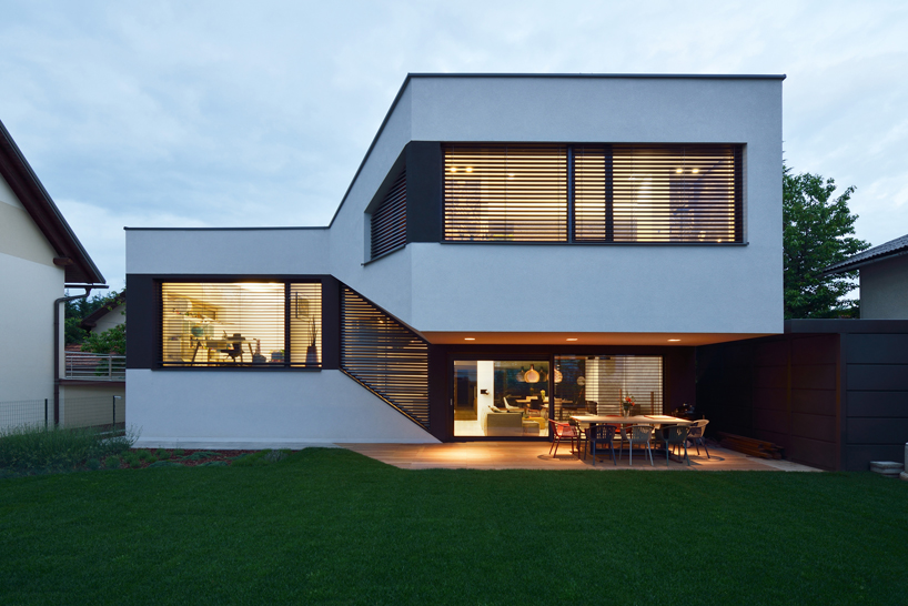 elastik + hikikomori's mezzanine house in ljubljana uses a cantilever to shelter exterior terrace