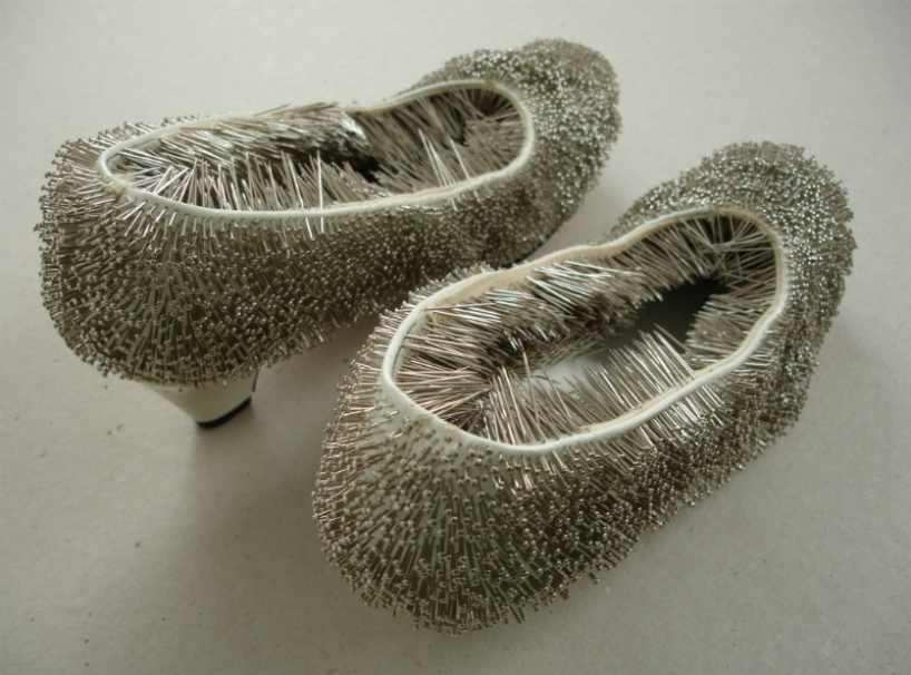 erwina ziomkowska pinches wardrobe garments with spiky pins