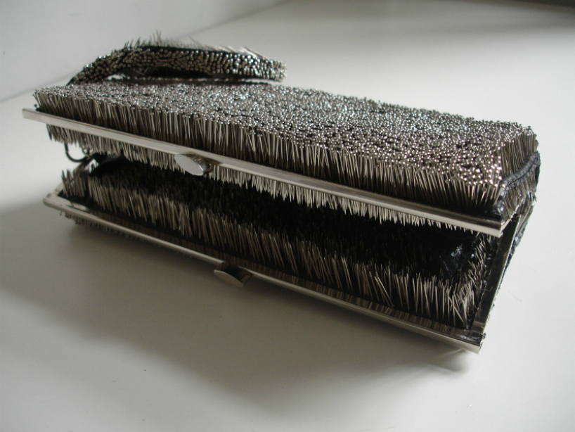 erwina ziomkowska pinches wardrobe garments with spiky pins