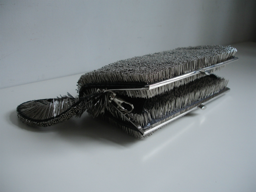 erwina ziomkowska pinches wardrobe garments with spiky pins